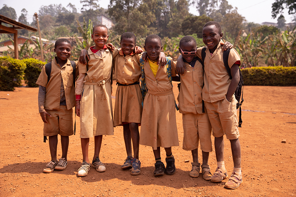 Group of schoolchildren standing out in the schoolyard. Friendship concept