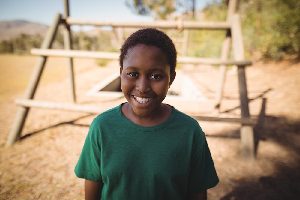portrait-of-smiling-boy-standing-in-boot-camp-duri-2026-01-11-10-31-06-utc