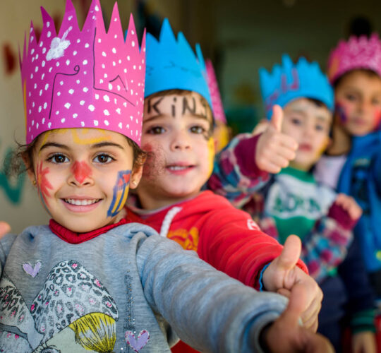 Syrian refugee children head home with crowns and painted faces after another fun day at one of the Child Friendly Space and Early Childhood Education centers for Syrian Refugee children, near Zahle' in Bekaa, Lebanon.